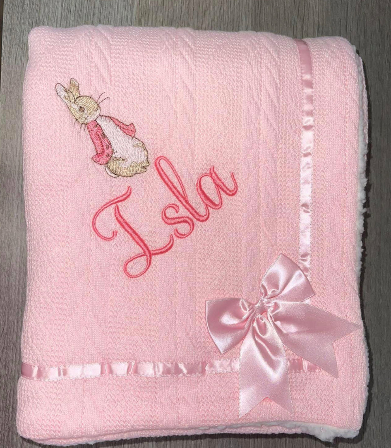 Beautiful personalised cable knit bow blanket with Flopsy Rabbit